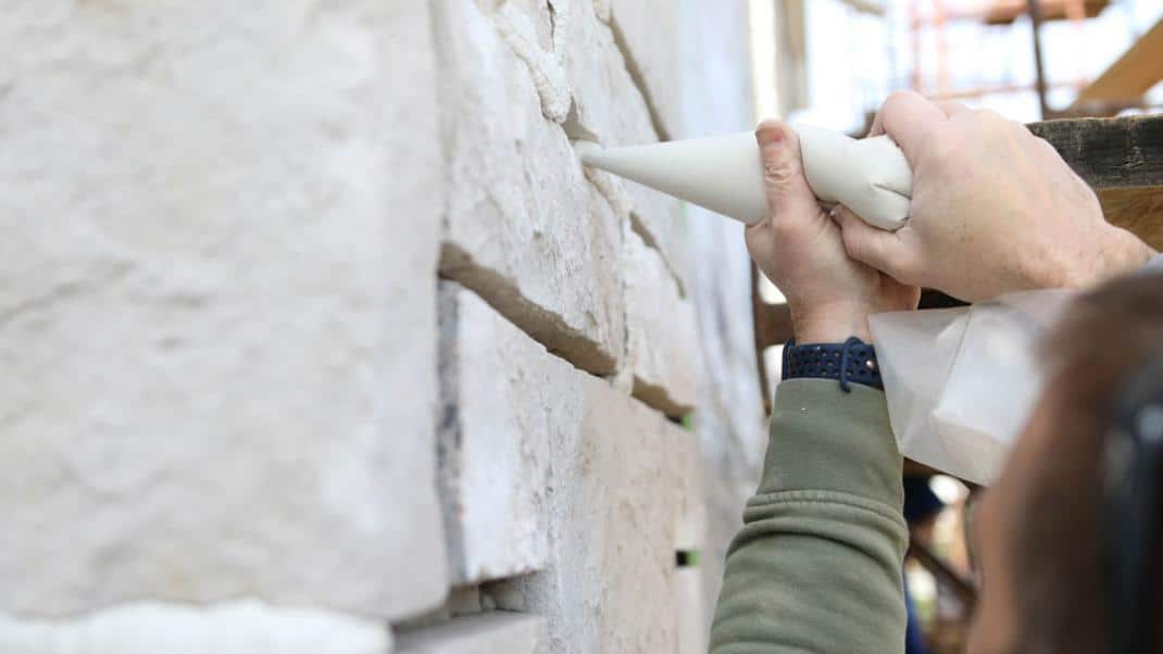 applying-grout_0 Someone Applying Grout to Veneer Stone